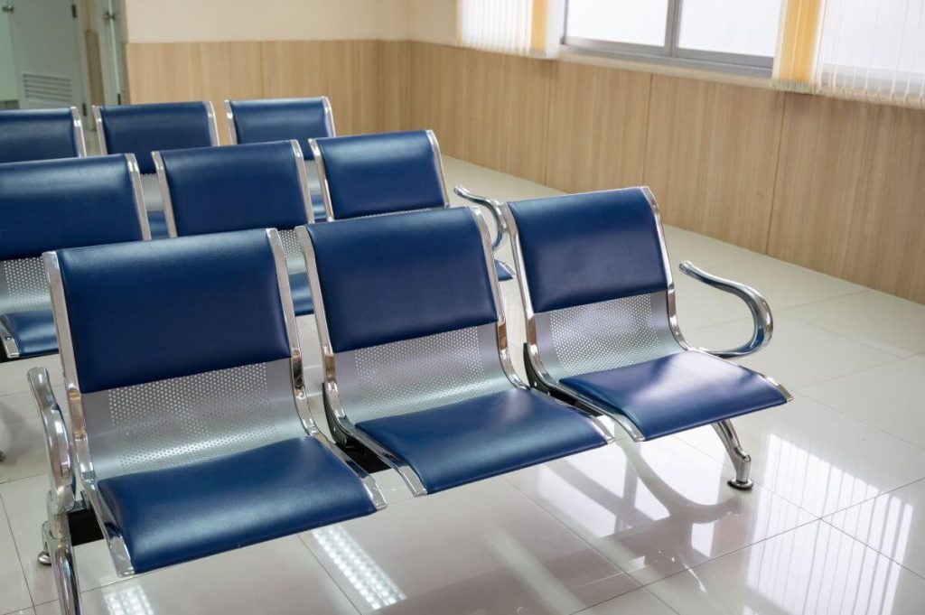 Row of blue commercial bench chairs in a reception area after cleaning