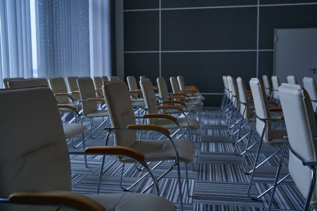 Empty conference venue with chairs arranged before event cleaning