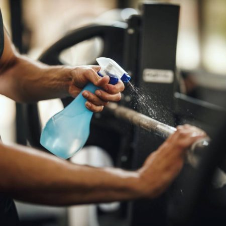Sanitazing the equipment in a gym post covid