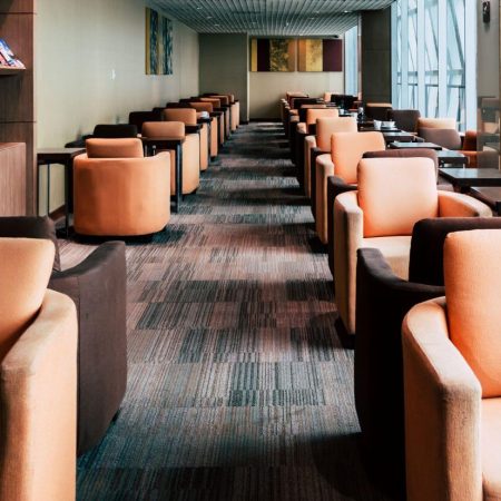 Clean commercial lounge with upholstered armchairs in a modern waiting area