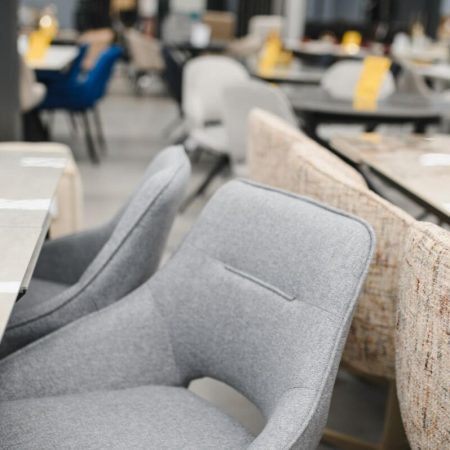 Modern upholstered dining chairs displayed in a commercial setting