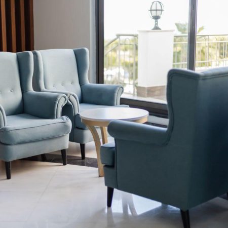 Blue upholstered armchairs in a hotel lounge seating area