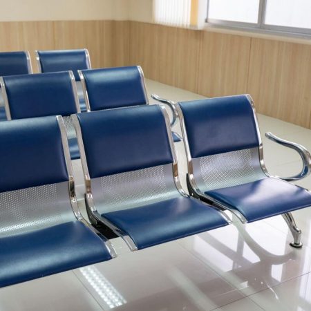 Row of blue commercial bench chairs in a reception area after cleaning